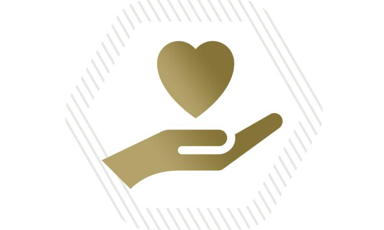 a Tech gold hand holding a heart icon with a gray hexagon around it